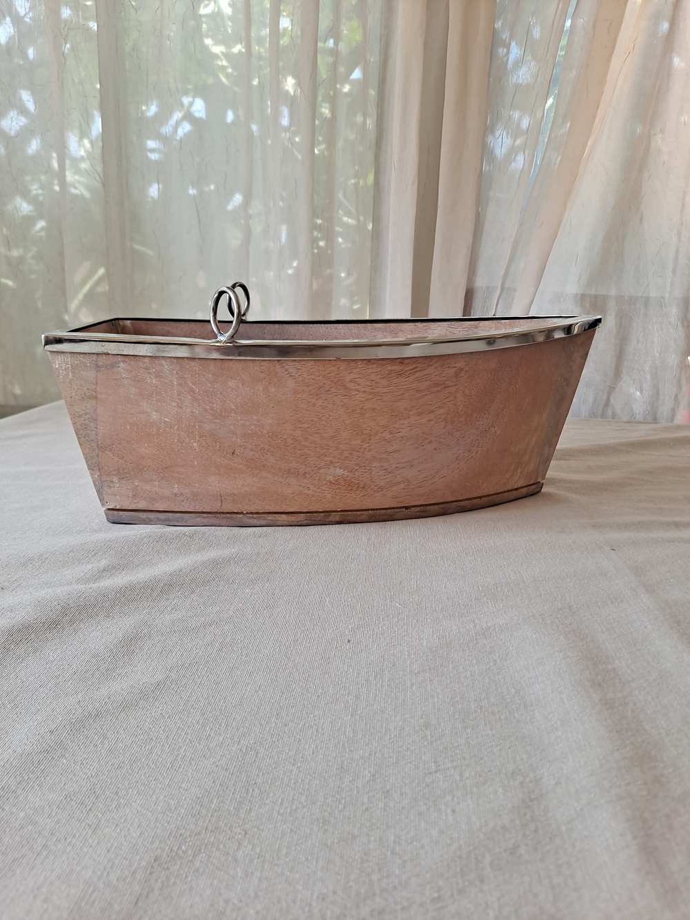 This decorative boat is a wooden serving bowl or tray, frequently identified as